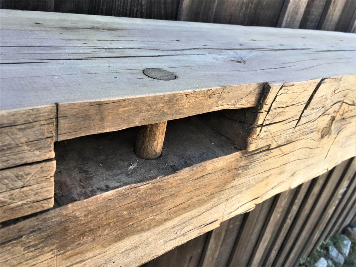 Hand Hewn Mantel closeup with Mortises and Unfinished