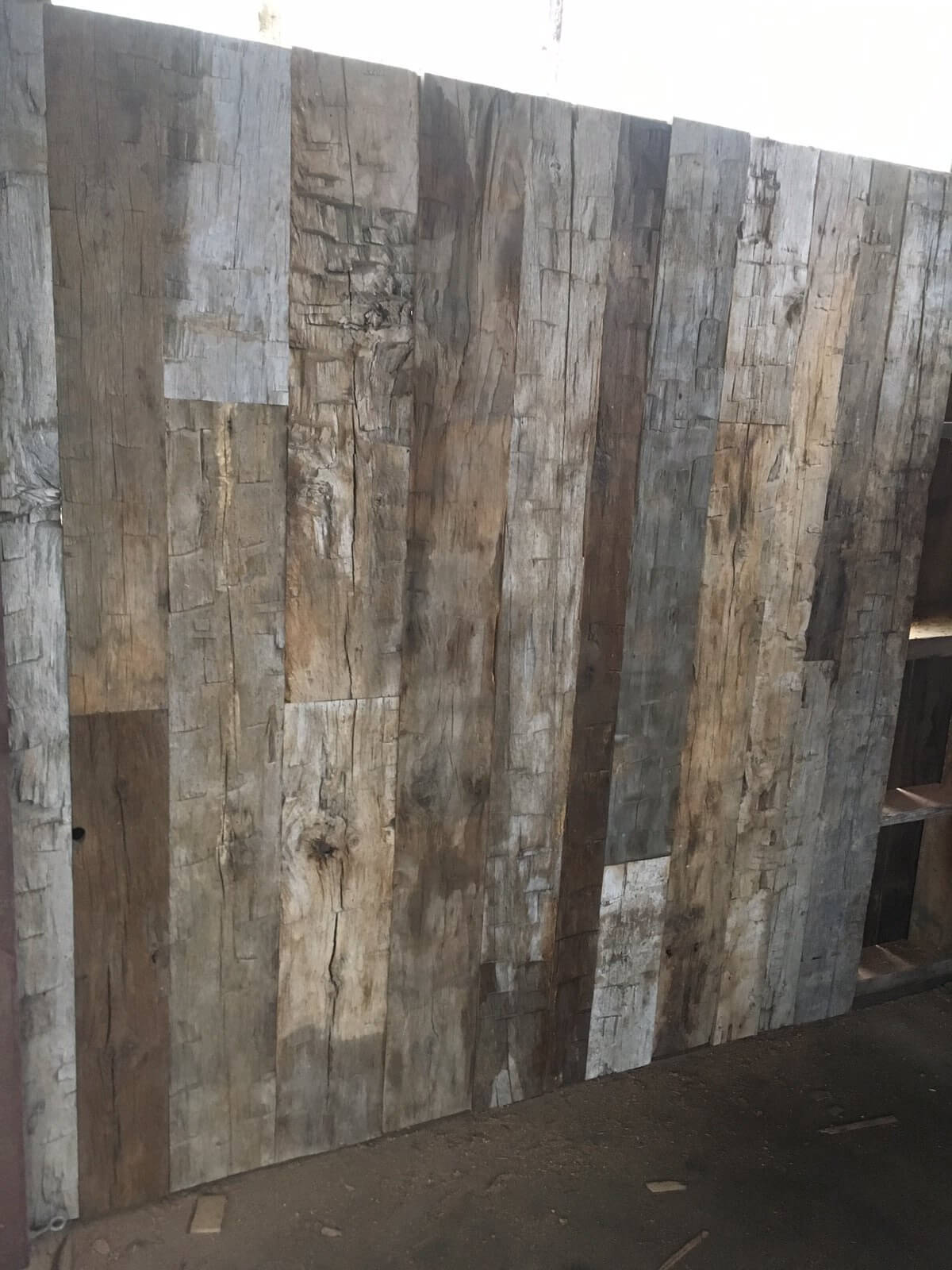 Reclaimed wood accent wall from hand hewn reclaimed wood.