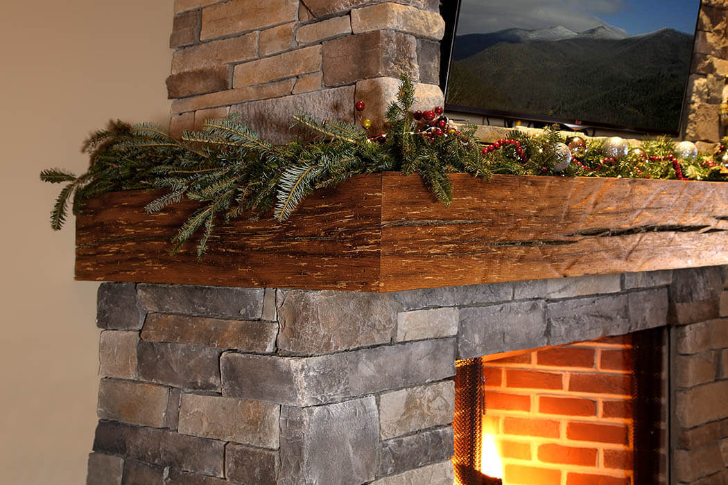 three-sided Reclaimed Oak rippled textured mantel over a brick fireplace