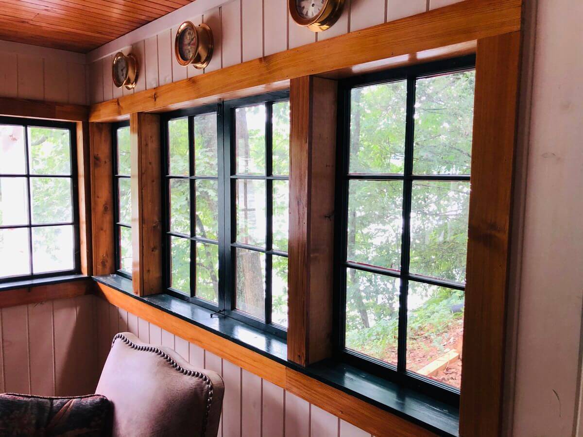 vertical grain heart pine trim boards around black rim windows in lake lure,nc