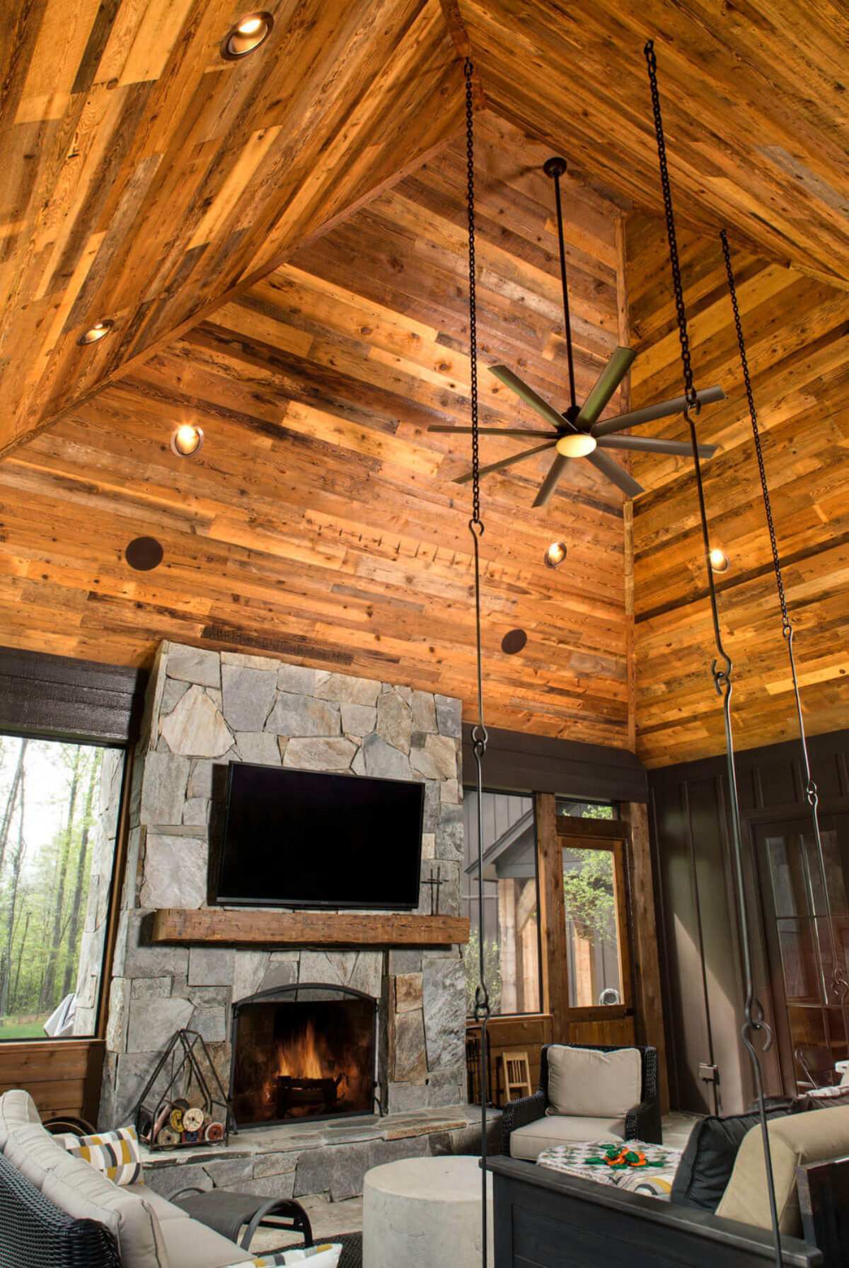 Reclaimed mixed Pine results in stunning vaulted reclaimed wood ceiling in living room.