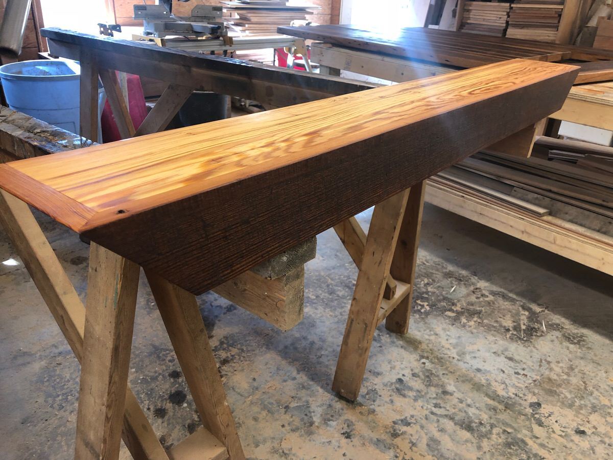 reclaimed heart pine mantel in isosceles trapezoid shape in wood shop
