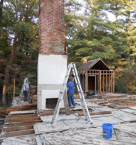 Reclaiming brick from old chimney.
