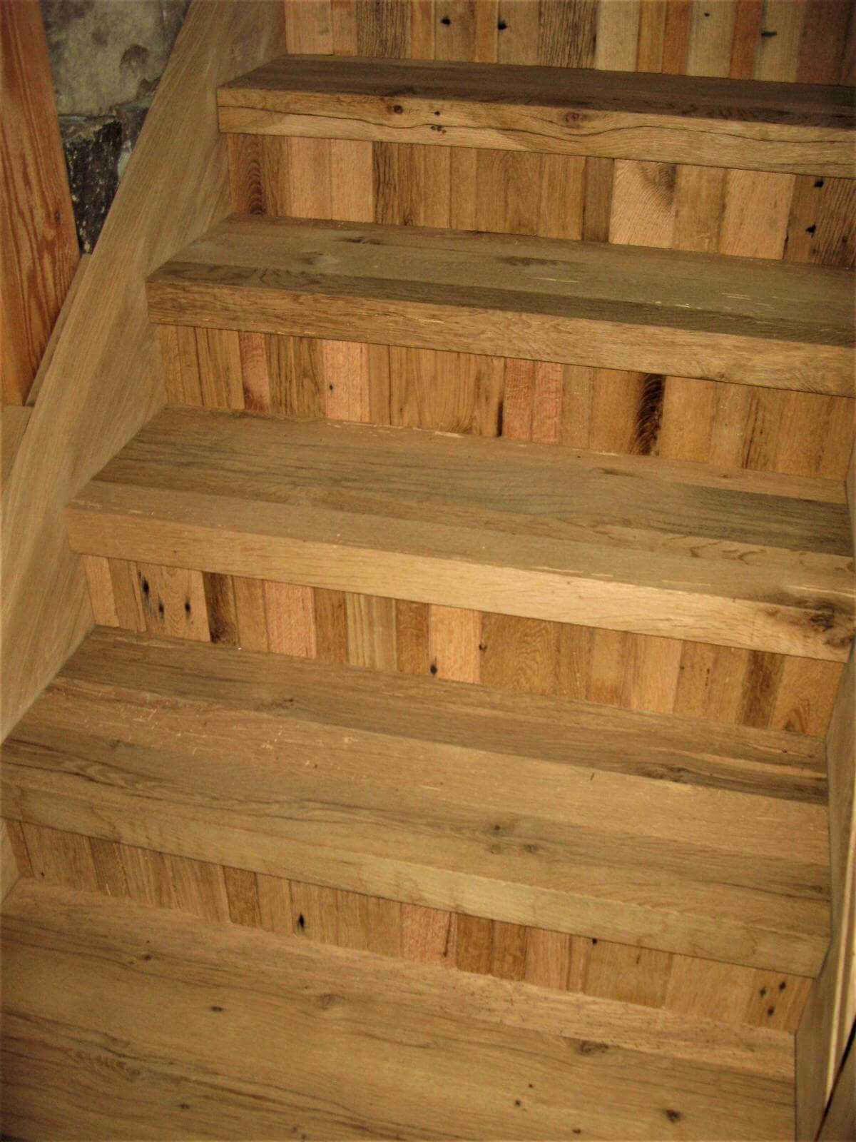 rustic hardwood stairs with narrow width vertical board risers