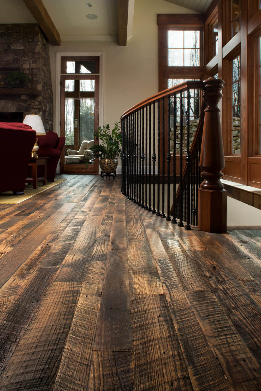 Dark rustic oak flooring near stairwell in Black Mountain North Carolina home.