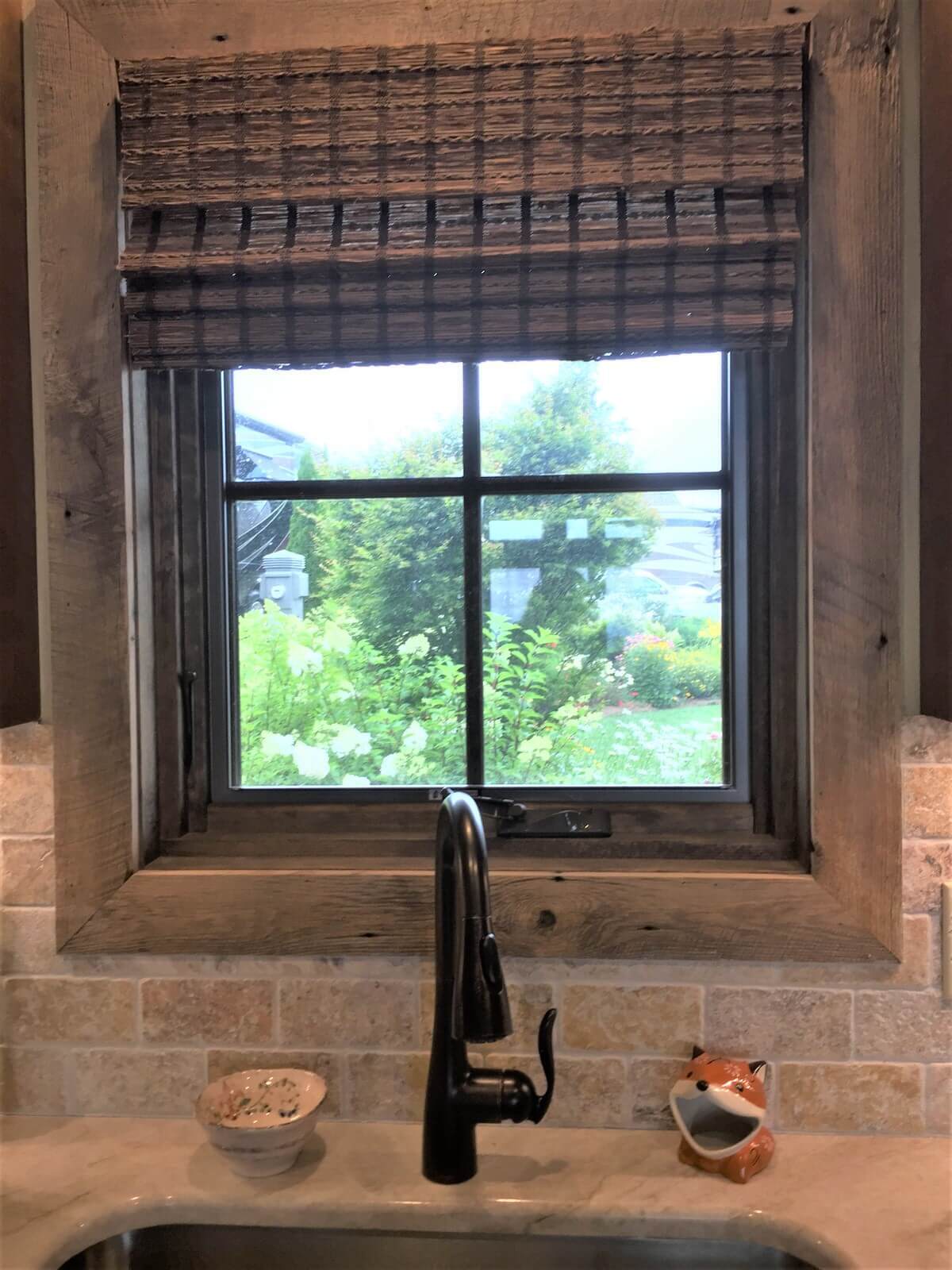 Rustic recessed window and  trim in a tile wall overlooking a garden