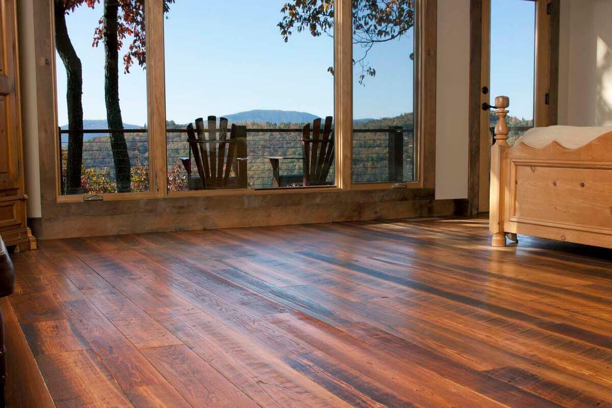 Refined rustic wood floors in master bedroom with mountain views.
