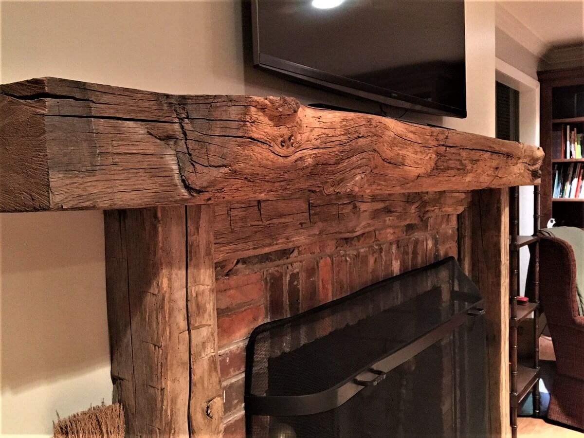 live edge rustic wood mantel with hand hewn support timbers