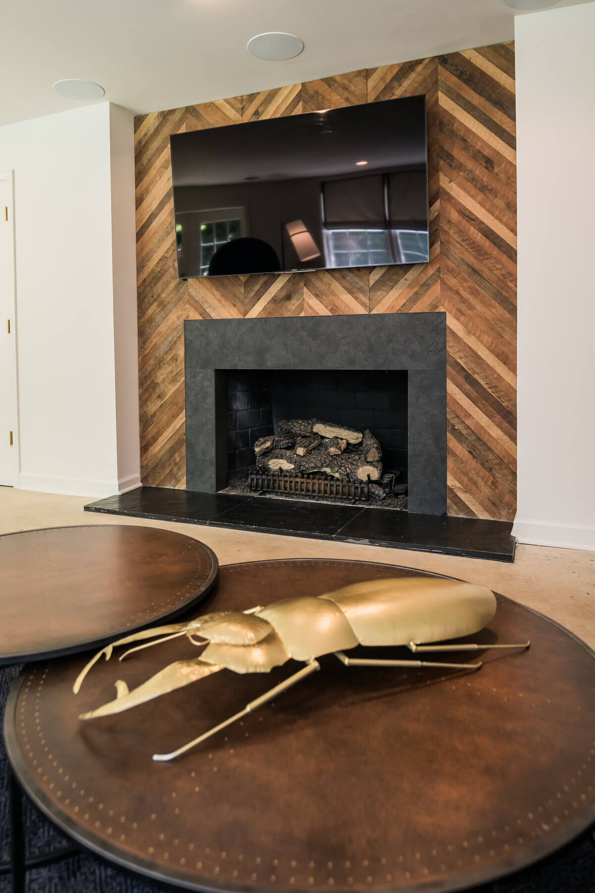 Reclaimed wood accent wall behind fireplace in living room.