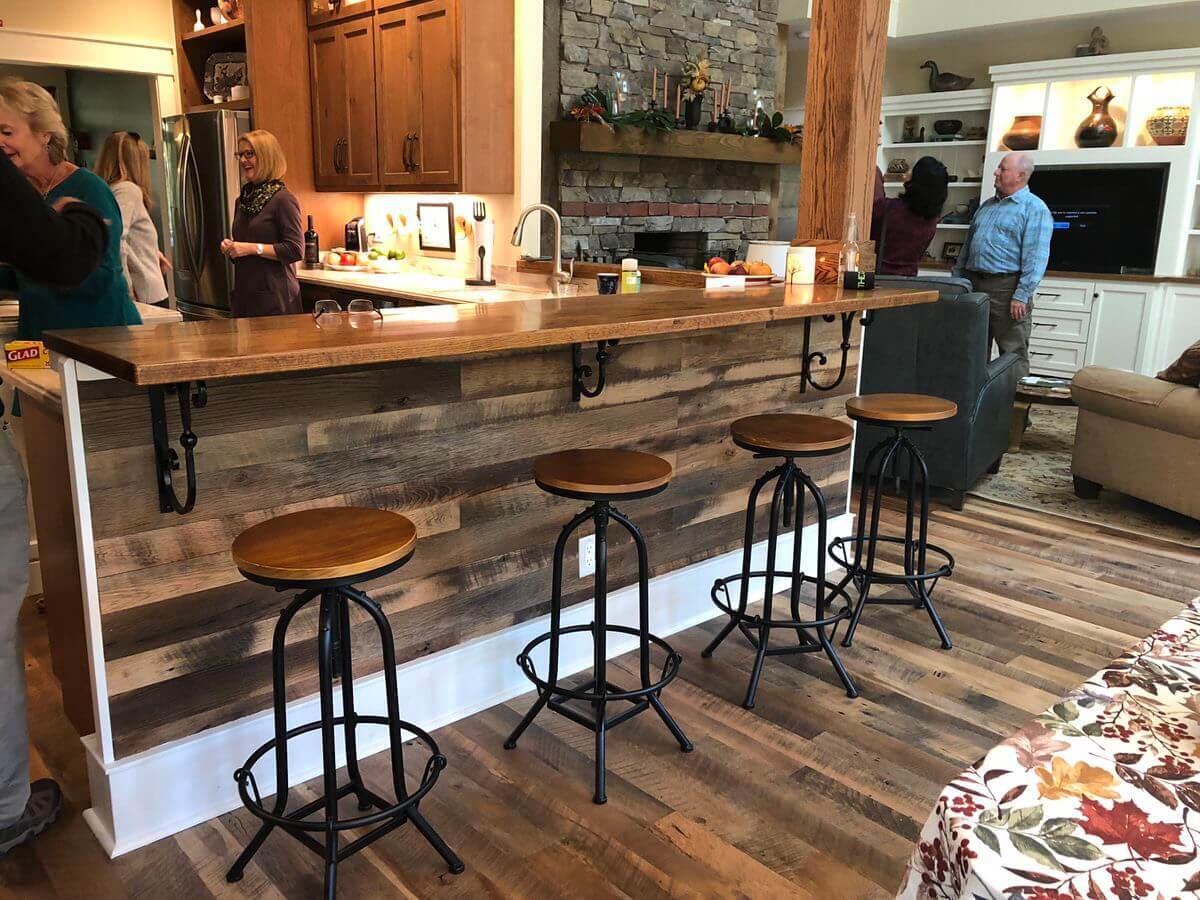 reclaimed wood side of a bar top with 4 stools in a saluda nc home